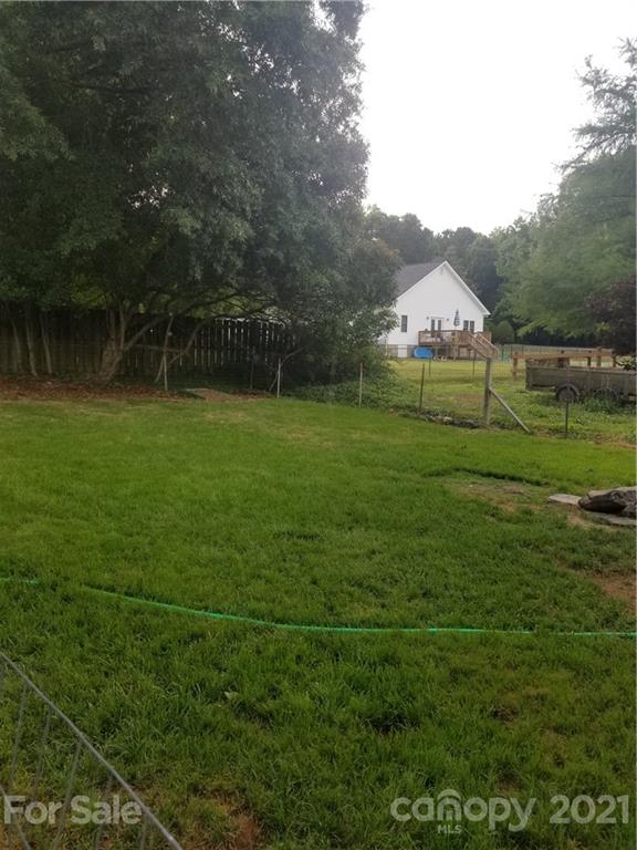203 North Love Chapel Road Stanfield, NC 28163 - Photo 19 of 19 a view of a green field with wooden fence