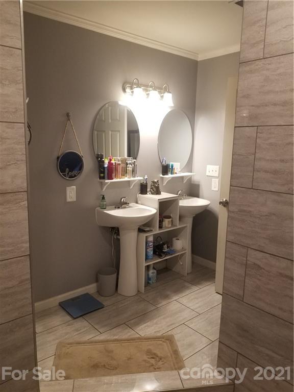 203 North Love Chapel Road Stanfield, NC 28163 - Photo 9 of 19 a bathroom with a sink and a mirror