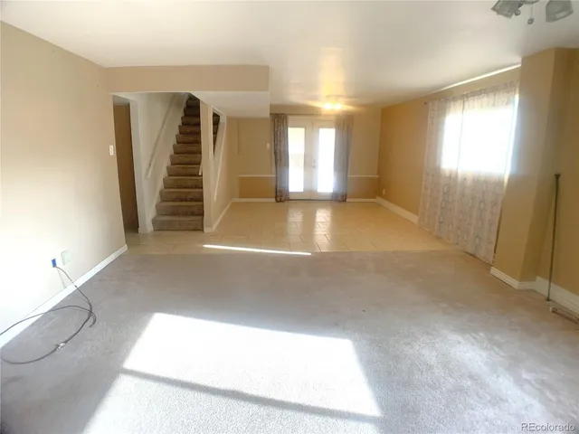 a view of an empty room with stairs
