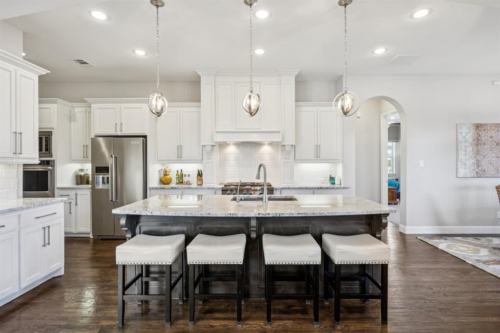 1392 Rolling Thunder Road Frisco, TX 75036 - Photo 14 of 40 a large kitchen with a table and chairs