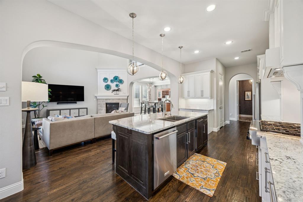 1392 Rolling Thunder Road Frisco, TX 75036 - Photo 16 of 40 a spacious bathroom with a sink a large mirror and a flat screen tv