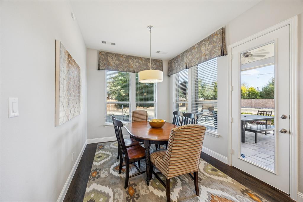 1392 Rolling Thunder Road Frisco, TX 75036 - Photo 18 of 40 a dining room with furniture large windows and a chandelier
