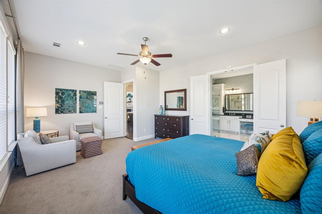 1392 Rolling Thunder Road Frisco, TX 75036 - Photo 20 of 40 a spacious bedroom with a bed a couch and a chandelier