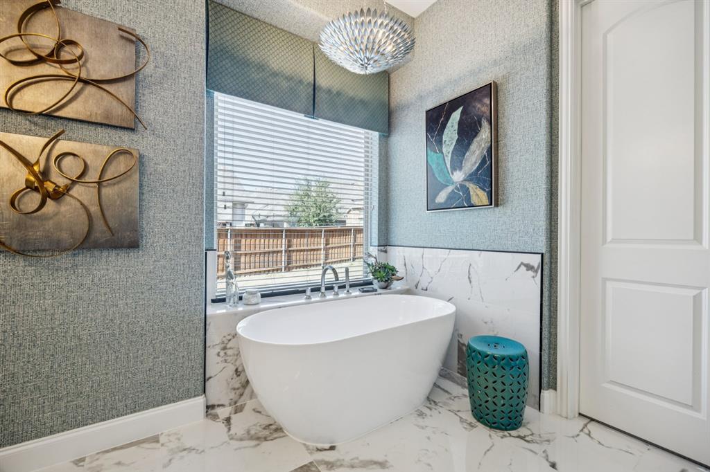 1392 Rolling Thunder Road Frisco, TX 75036 - Photo 24 of 40 a bathroom with a bathtub and shower