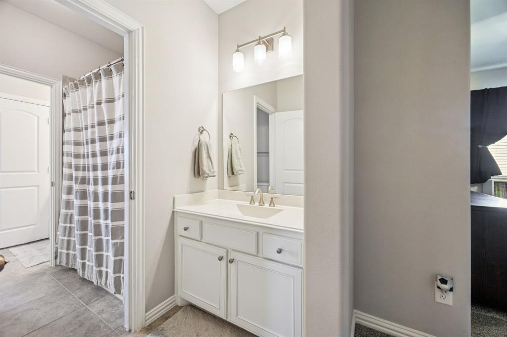 1392 Rolling Thunder Road Frisco, TX 75036 - Photo 30 of 40 a bathroom with a sink and a mirror