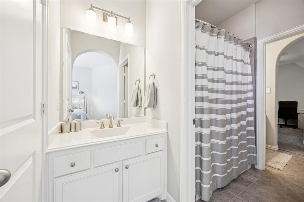 1392 Rolling Thunder Road Frisco, TX 75036 - Photo 31 of 40 a bathroom with a double vanity sink mirror and shower