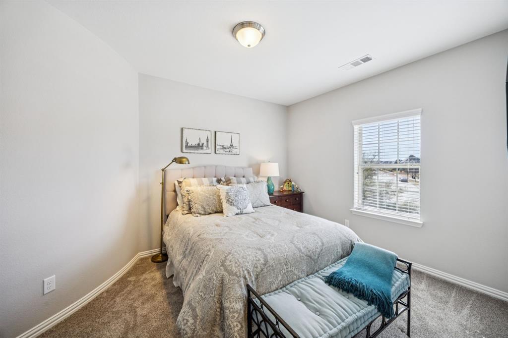 1392 Rolling Thunder Road Frisco, TX 75036 - Photo 32 of 40 a bedroom with a bed and a window