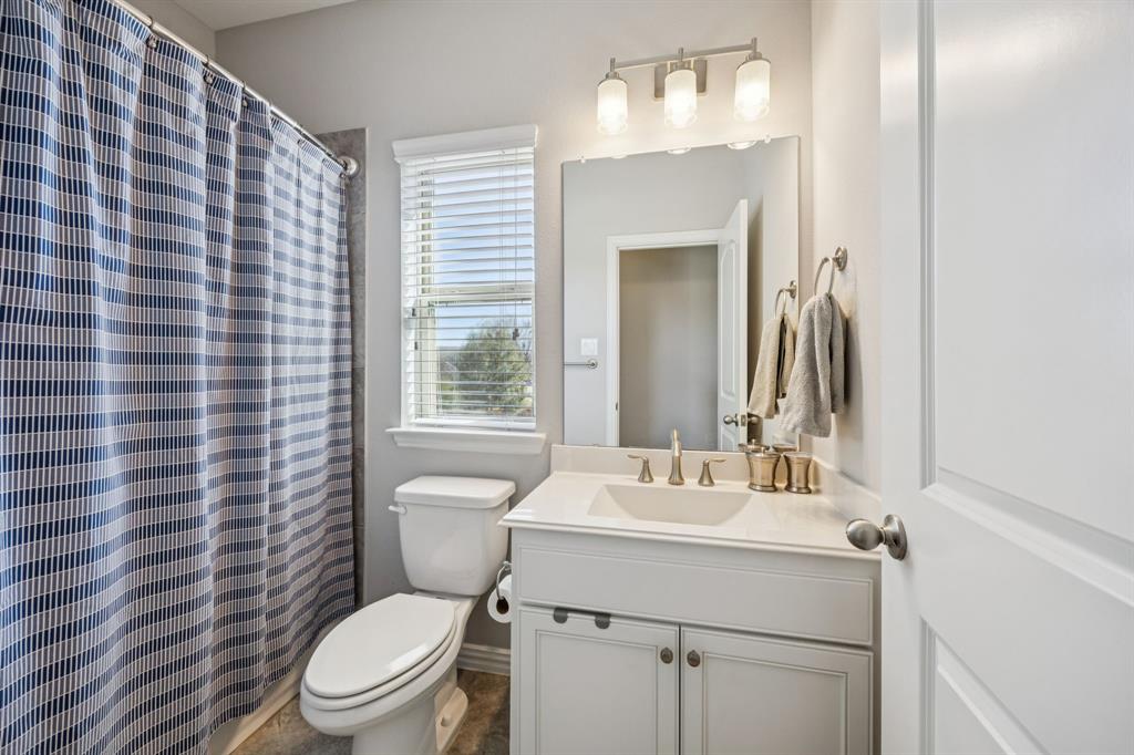 1392 Rolling Thunder Road Frisco, TX 75036 - Photo 34 of 40 a bathroom with a sink mirror vanity and toilet