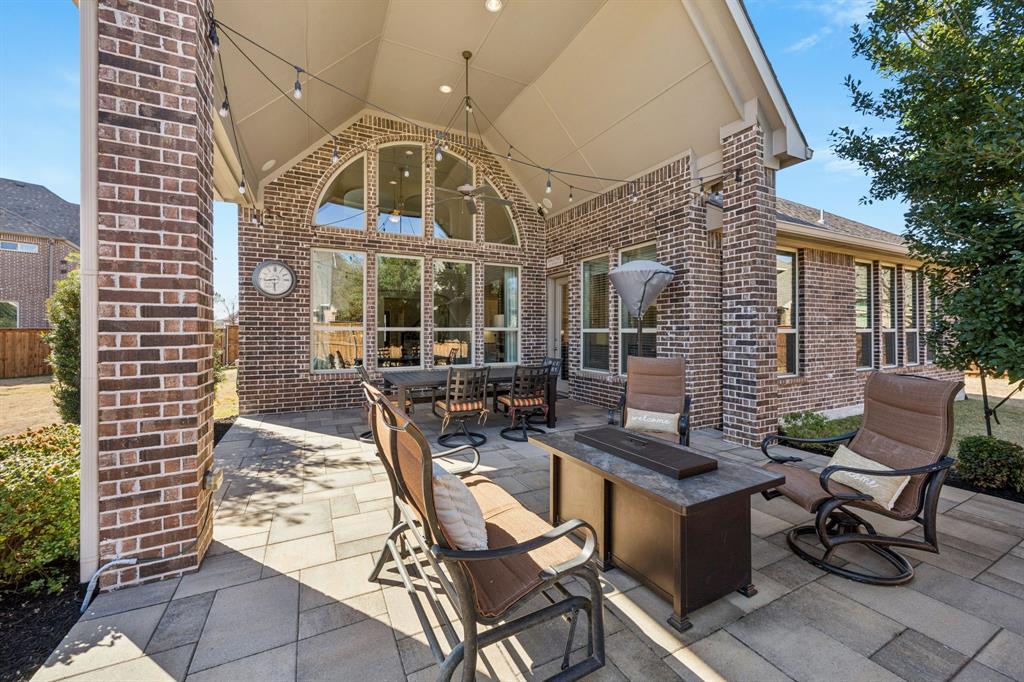 1392 Rolling Thunder Road Frisco, TX 75036 - Photo 39 of 40 a view of a patio with a dining table and chairs with wooden floor