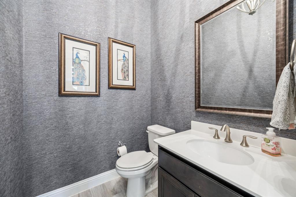 1392 Rolling Thunder Road Frisco, TX 75036 - Photo 8 of 40 a bathroom with a sink a toilet and a mirror