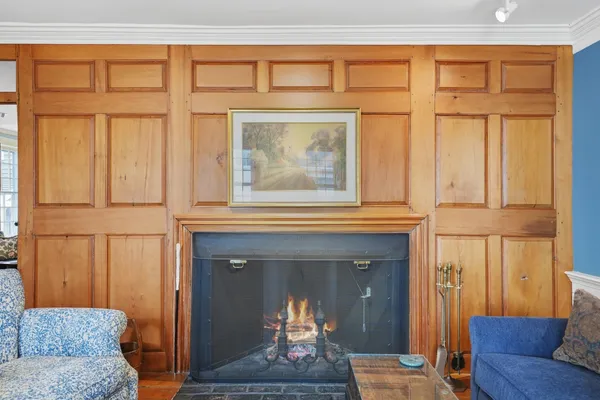 a living room with furniture a fireplace and a large window