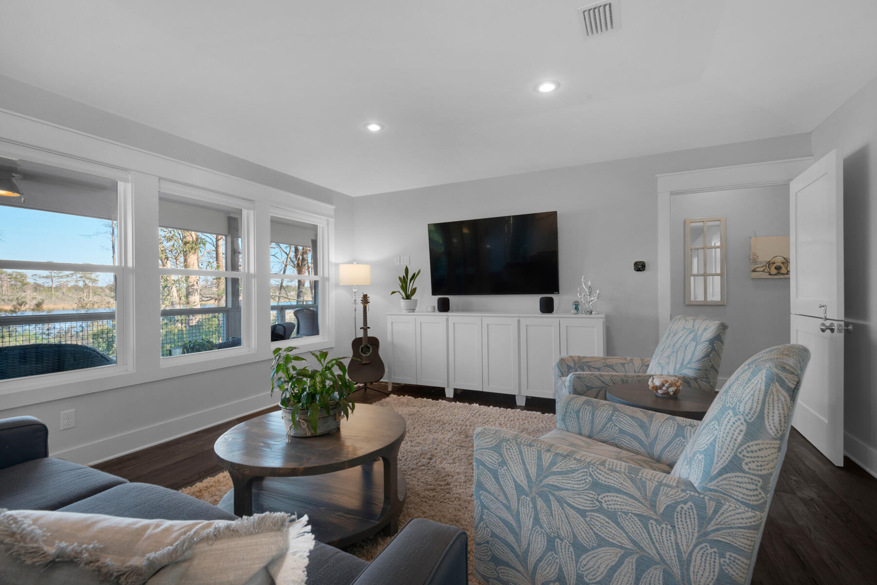 515 Whitfield Road Freeport, FL 32439 - Photo 13 of 39 a living room with furniture a flat screen tv and a large window