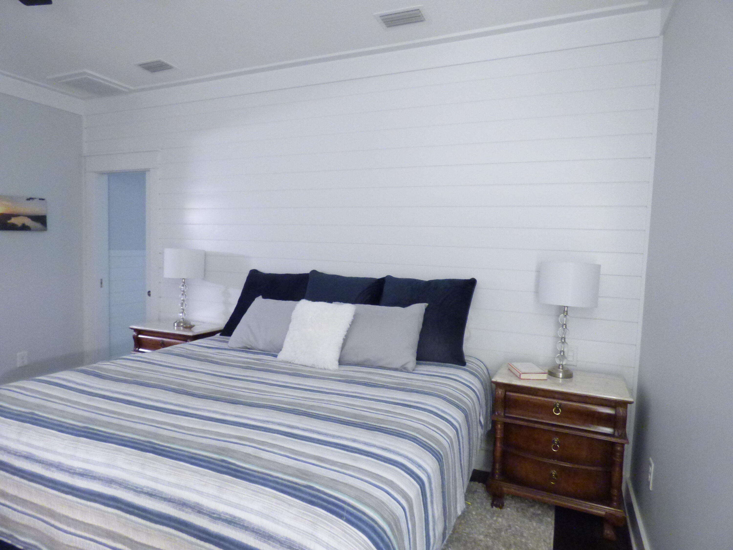 515 Whitfield Road Freeport, FL 32439 - Photo 17 of 39 a bedroom with a bed and a night stand