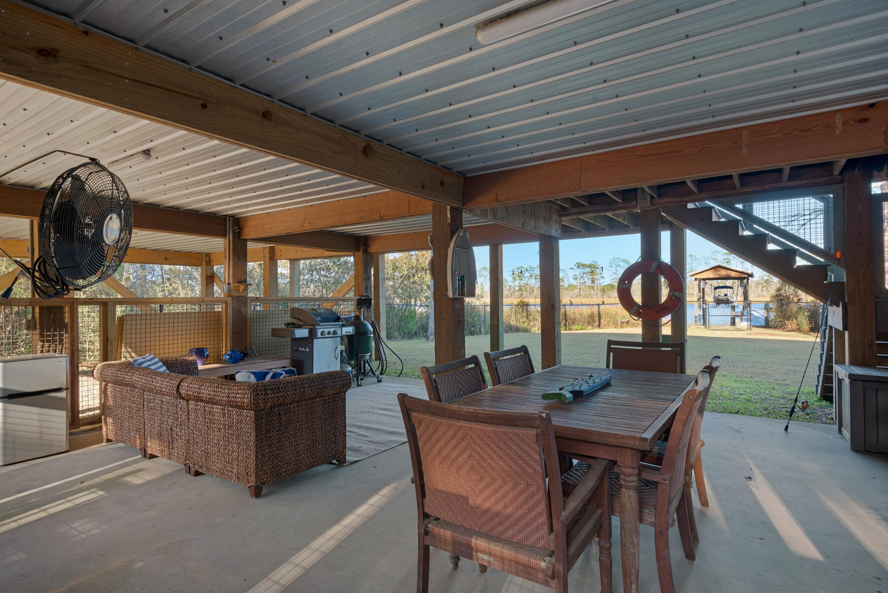 515 Whitfield Road Freeport, FL 32439 - Photo 33 of 39 a dining room with furniture and a floor to ceiling window