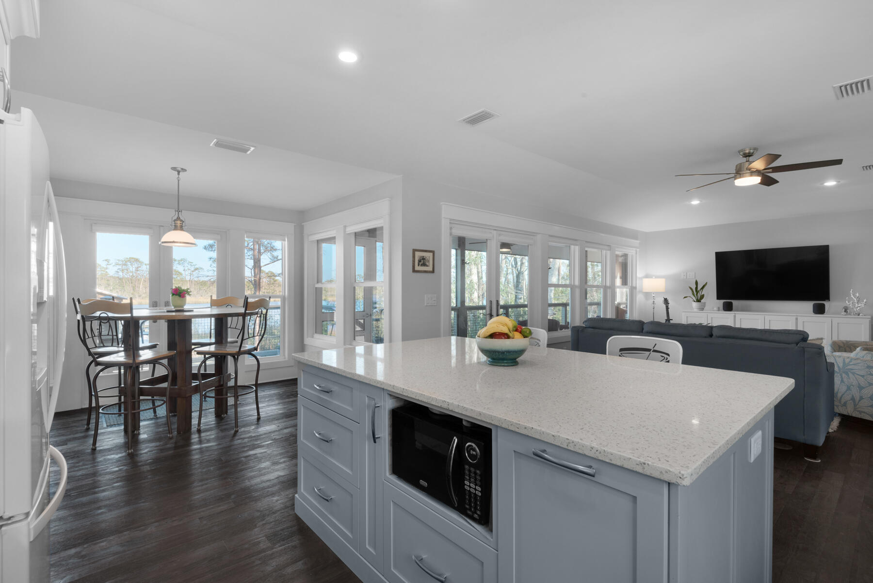 515 Whitfield Road Freeport, FL 32439 - Photo 9 of 39 a kitchen with stainless steel appliances a sink a stove and white cabinets with wooden floor