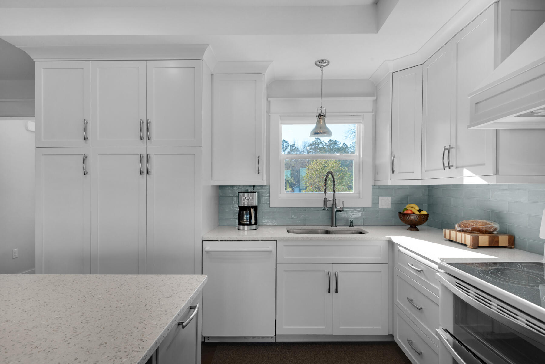 515 Whitfield Road Freeport, FL 32439 - Photo 10 of 39 a kitchen with a sink dishwasher and white cabinets with wooden floor