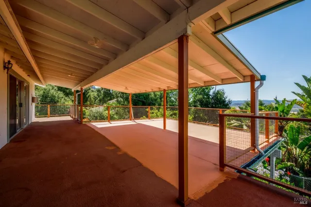a outdoor living space with furniture and a flat screen tv