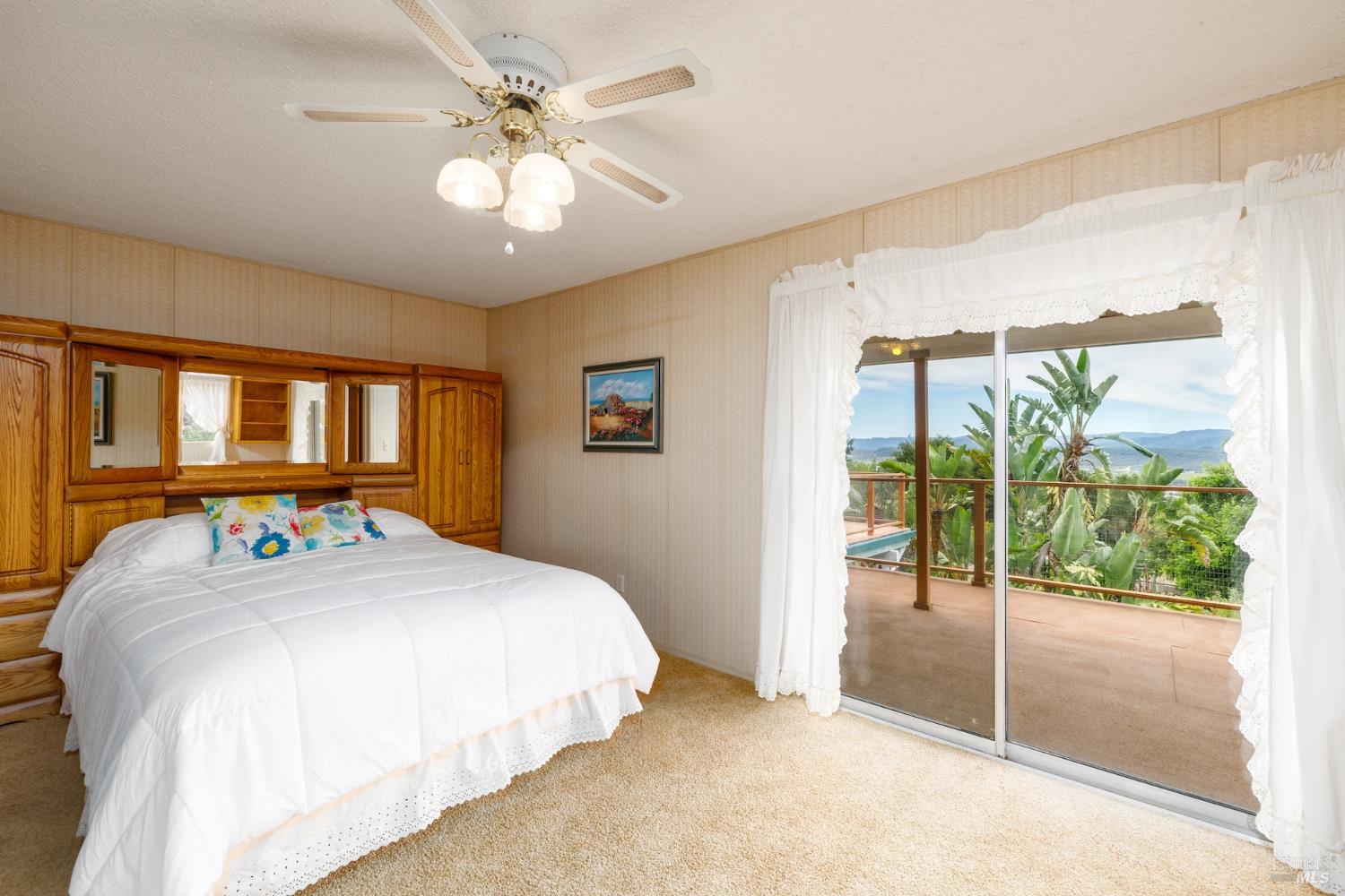 1135 Palomino Road Cloverdale, CA 95425 - Photo 21 of 42 a spacious bedroom with a bed and a chandelier