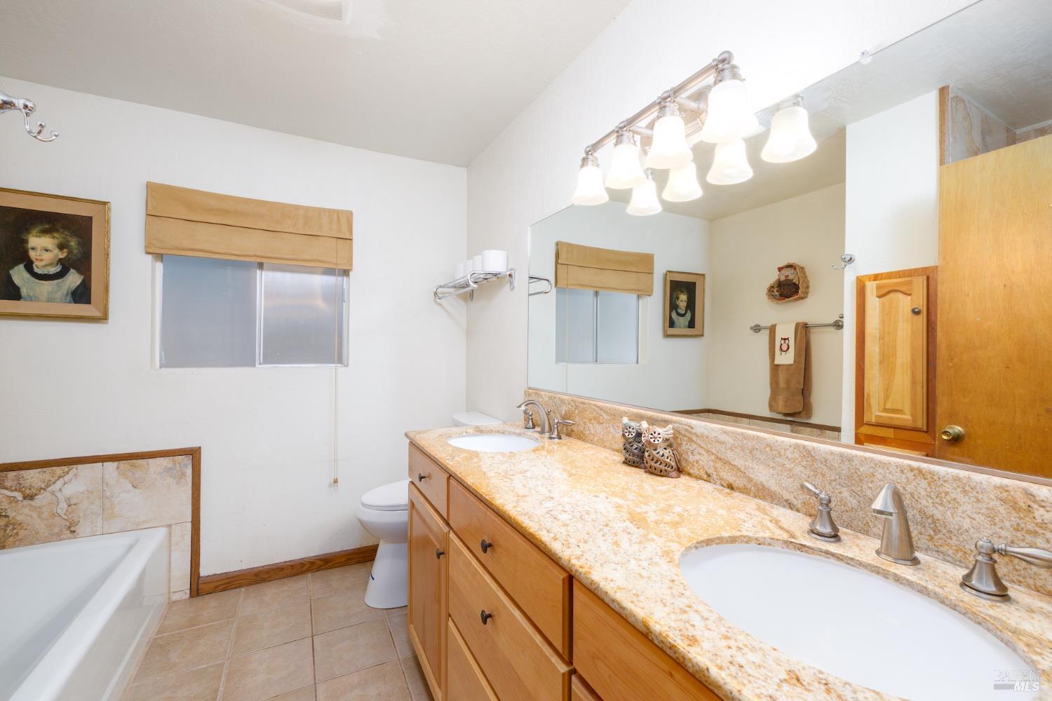 1135 Palomino Road Cloverdale, CA 95425 - Photo 22 of 42 a bathroom with a granite countertop double vanity sink and mirror