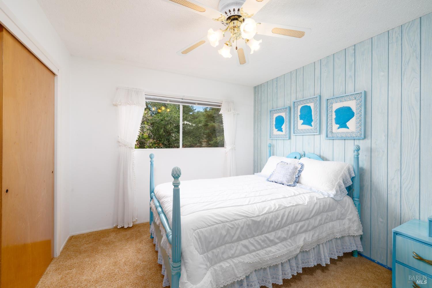 1135 Palomino Road Cloverdale, CA 95425 - Photo 23 of 42 a bedroom with a bed and a chandelier