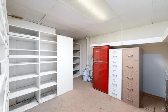 a view of a kitchen with furniture and an empty room