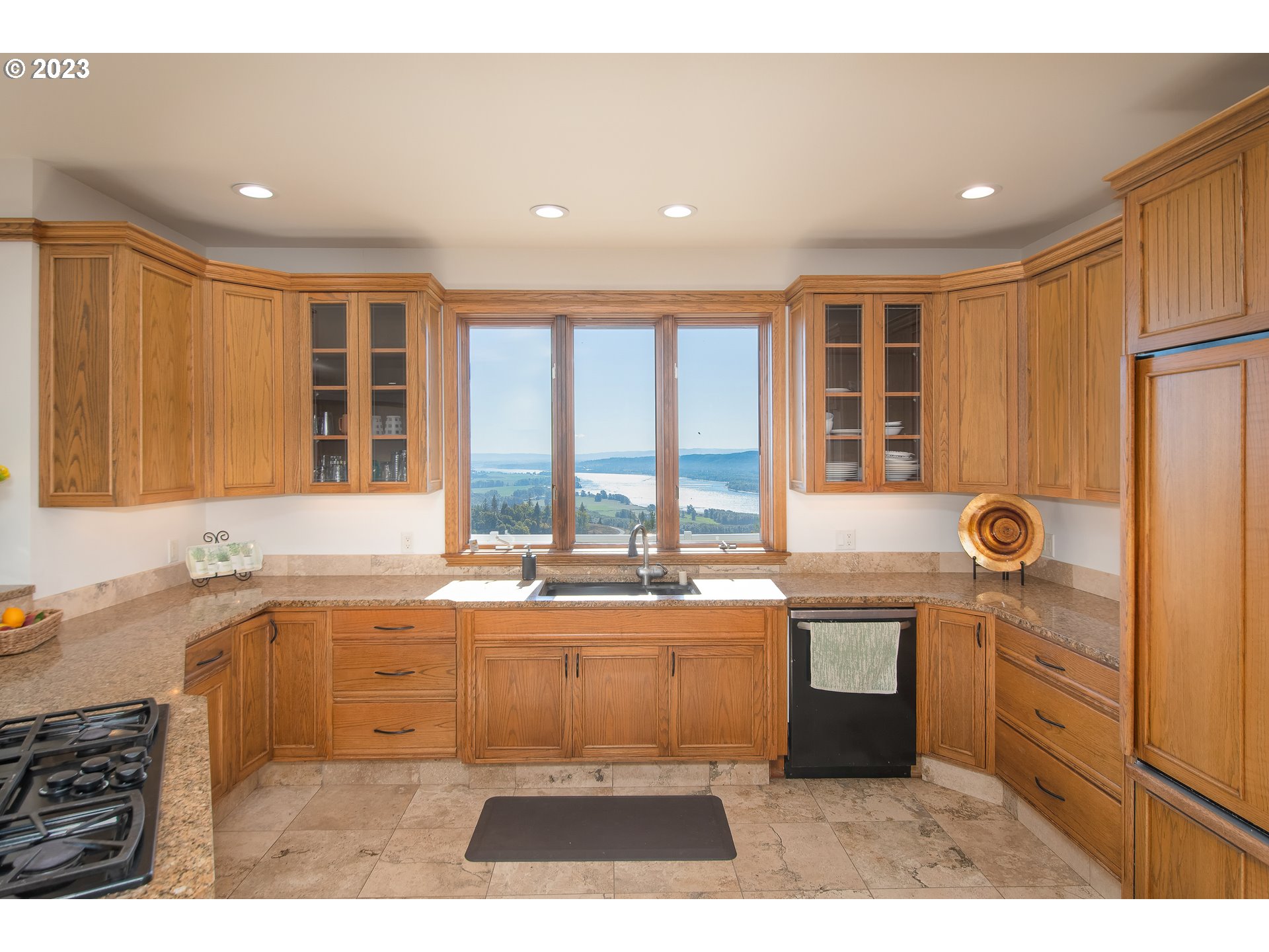 206 Pebble Lane Kalama, WA 98625 - Photo 13 of 47 a kitchen with a sink and a refrigerator