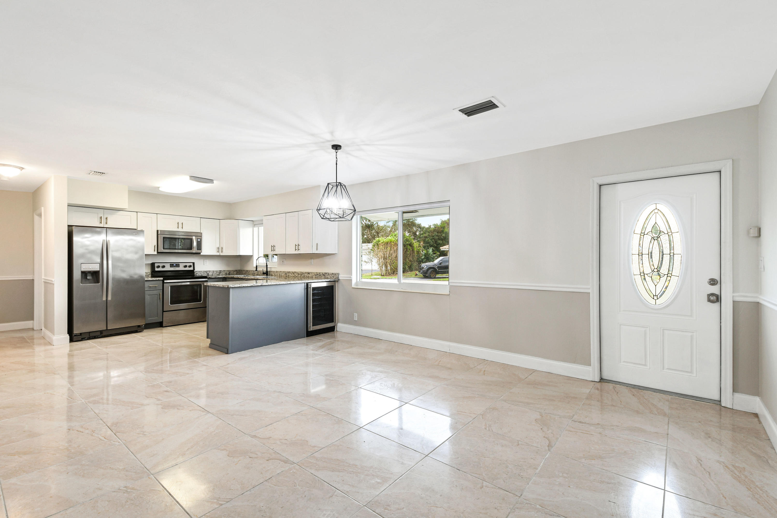 2003 Park Place Boca Raton, FL 33486 - Photo 11 of 42 a large white kitchen with a refrigerator a microwave oven a sink and a counter top space