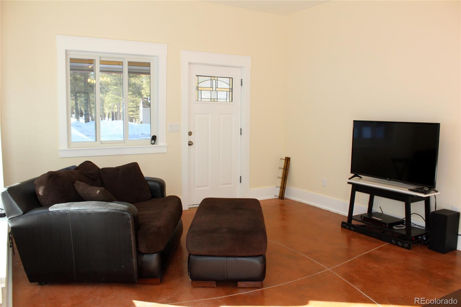 4147 Campfire Road Hartsel, CO 80449 - Photo 3 of 27 a living room with furniture and a flat screen tv
