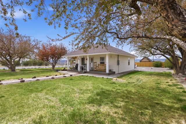 82 South 100 West Lyman, UT 84749 - Photo 10 of 27 View of front facade featuring covered porch and a shingled roof
