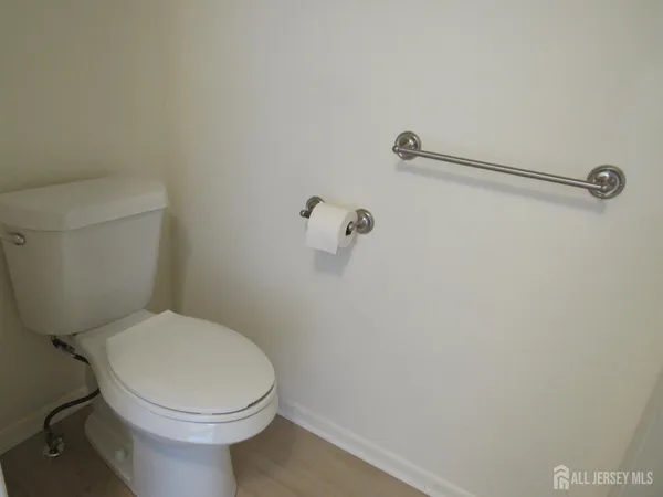 a white toilet sitting next to a shower