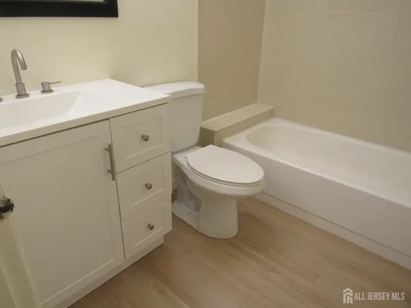 a bathroom with a sink a toilet and bathtub