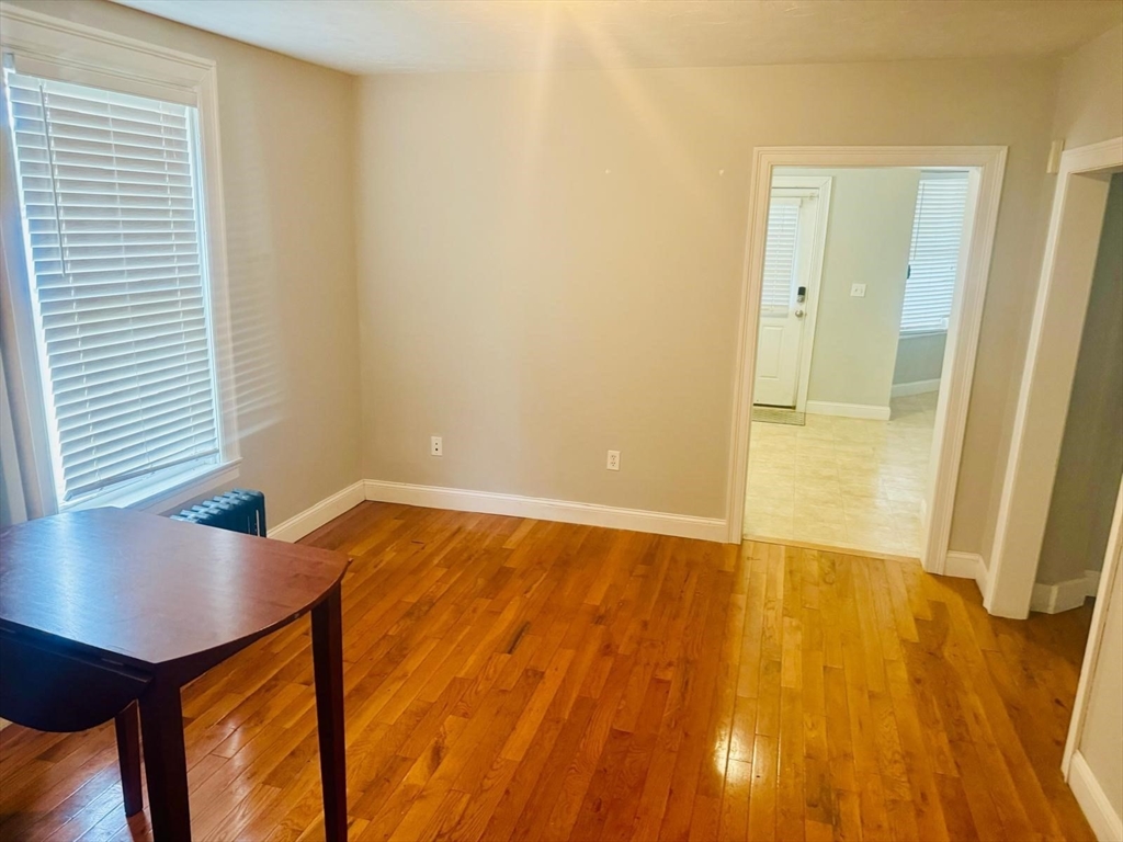 36 Cedar Street, Unit 1A Worcester, MA 01609 - Photo 12 of 19 an empty room with wooden floor and windows
