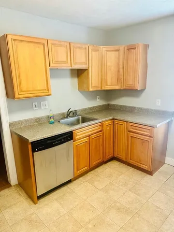 a kitchen with a sink cabinets and a window
