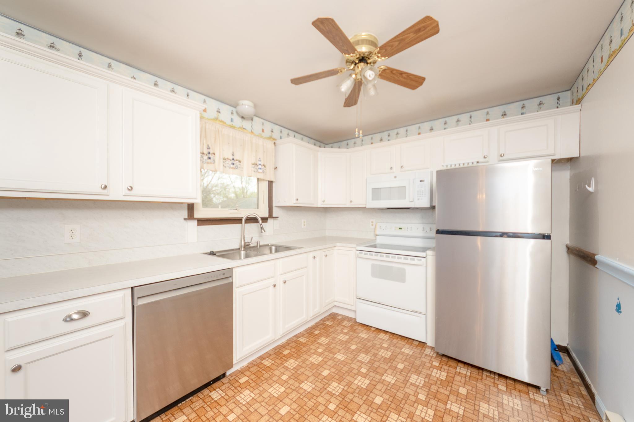17 Turnbridge Drive Lancaster, PA 17603 - Photo 14 of 32 a kitchen with a refrigerator a sink and dishwasher with white cabinets