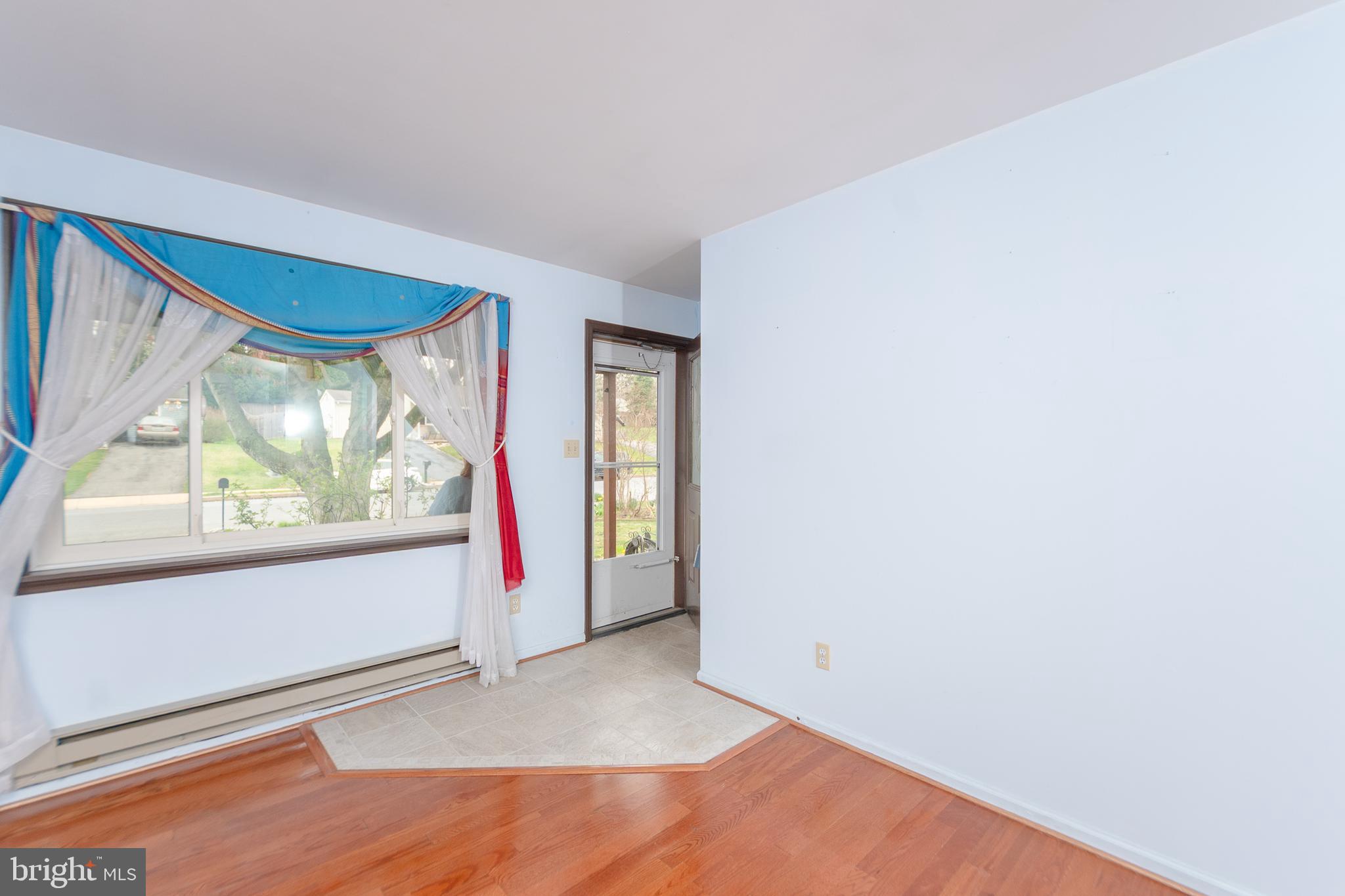17 Turnbridge Drive Lancaster, PA 17603 - Photo 9 of 32 an empty room with wooden floor and windows