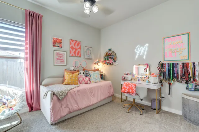 a bedroom with furniture and a flat screen tv