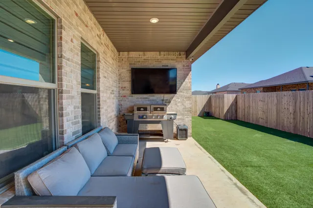 a view of a patio with couches chairs and a yard