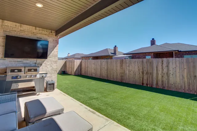 a view of a backyard with furniture and a backyard
