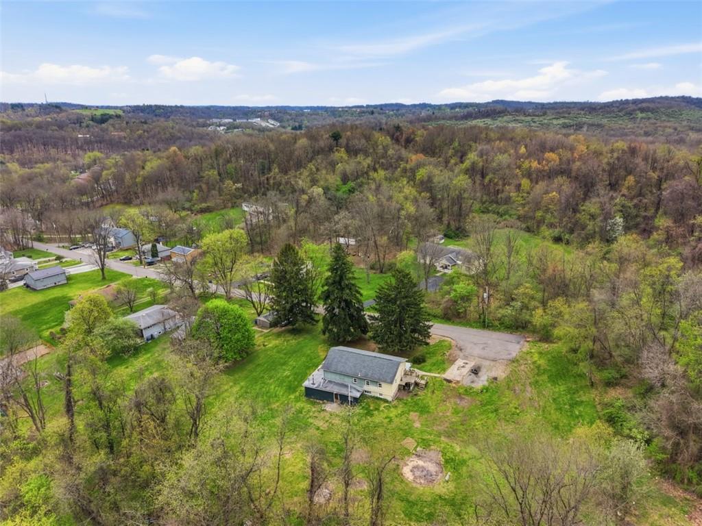 96 Meanor Street Imperial, PA 15126 - Photo 4 of 44 a view of a city with lush green forest