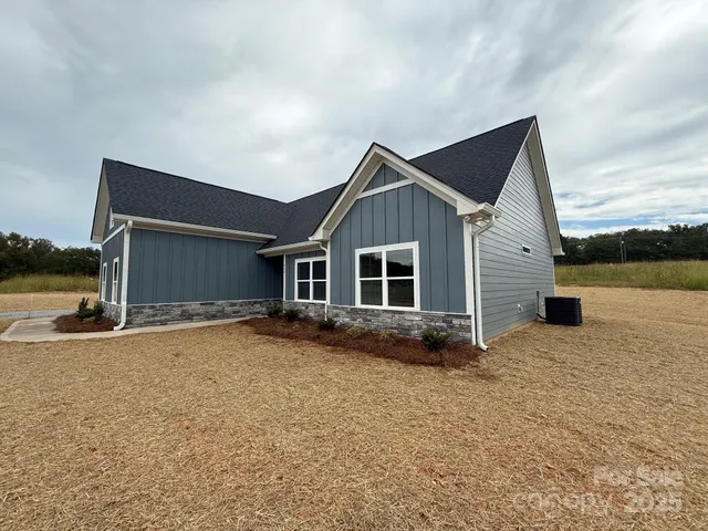 a view of a house with backyard and lake view