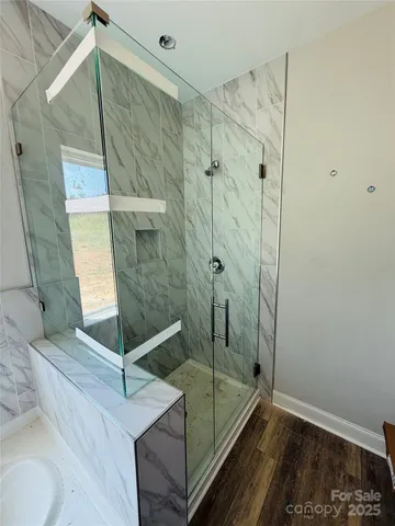 a bathroom with a glass shower door