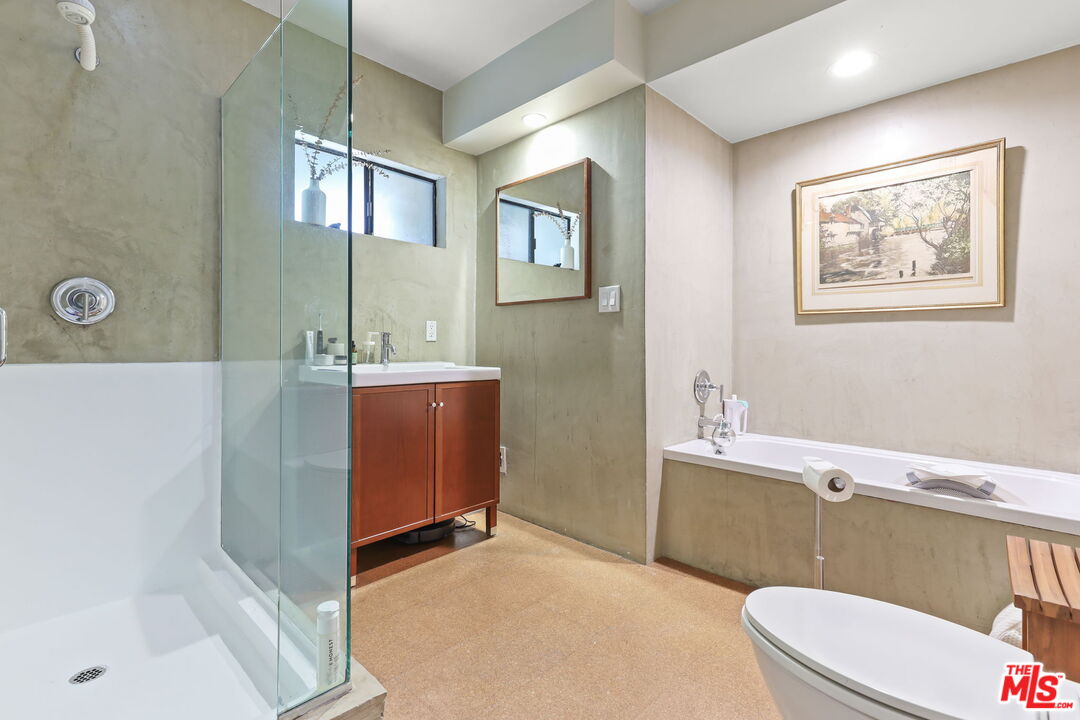 3765 Arbolada Road Los Angeles, CA 90027 - Photo 14 of 34 a bathroom with a bathtub sink mirror vanity and toilet