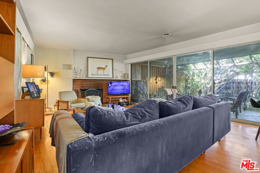 3765 Arbolada Road Los Angeles, CA 90027 - Photo 18 of 34 a living room with furniture and a large window