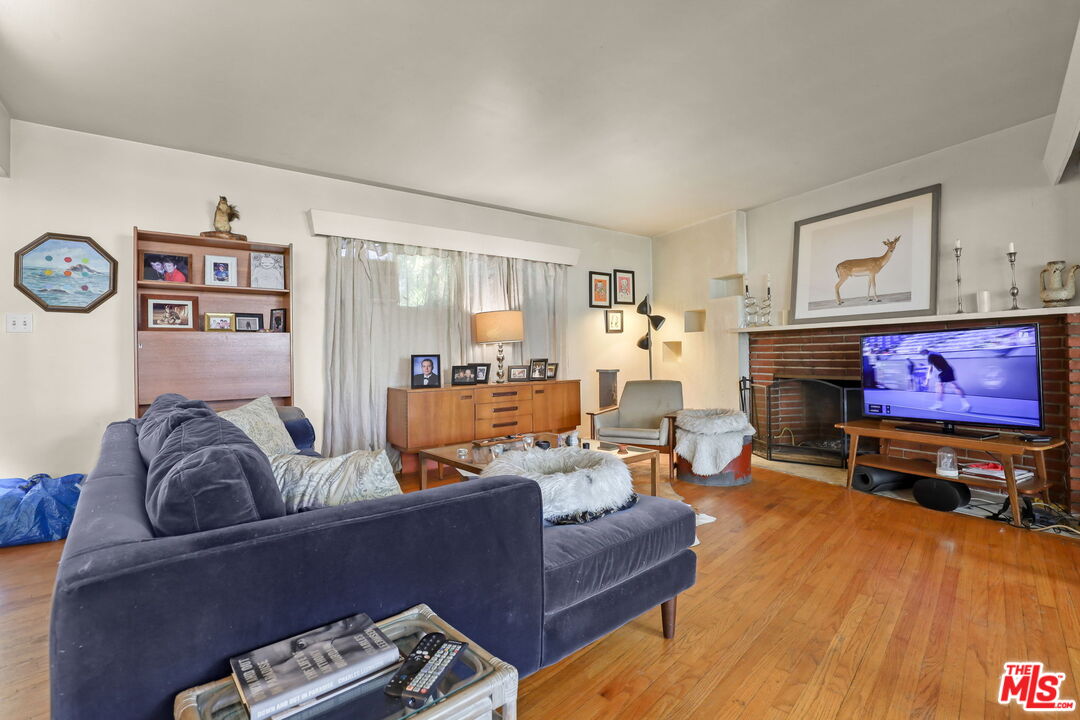 3765 Arbolada Road Los Angeles, CA 90027 - Photo 19 of 34 a living room with furniture and a flat screen tv