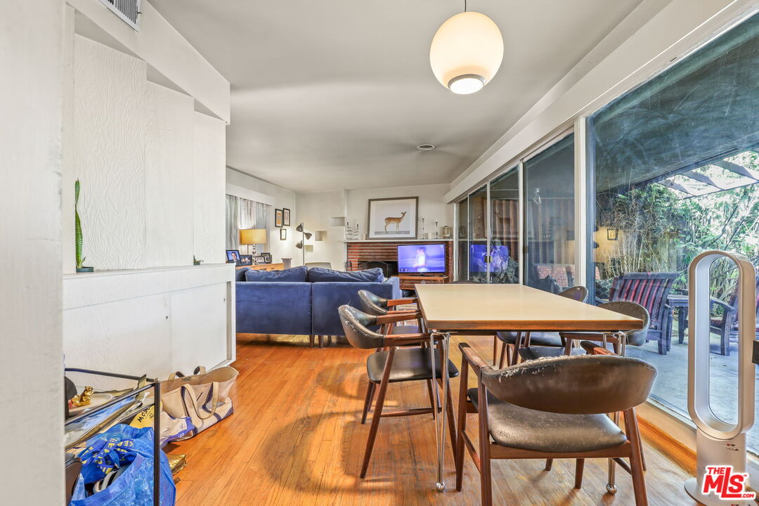 3765 Arbolada Road Los Angeles, CA 90027 - Photo 21 of 34 a view of a dining room with furniture and a large window