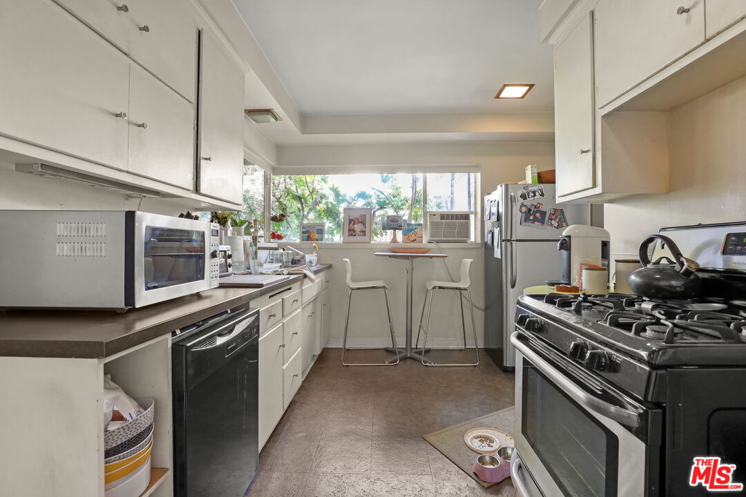 3765 Arbolada Road Los Angeles, CA 90027 - Photo 22 of 34 a kitchen with a stove and a sink