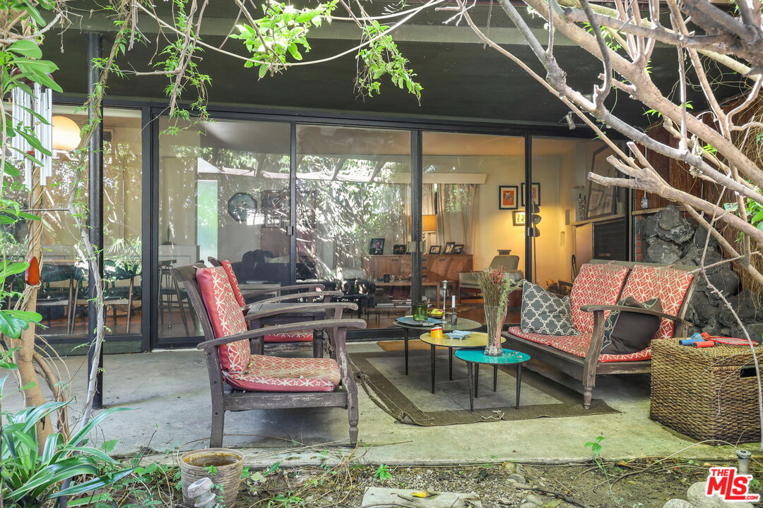 3765 Arbolada Road Los Angeles, CA 90027 - Photo 27 of 34 a view of a patio with couches chairs and a potted plant