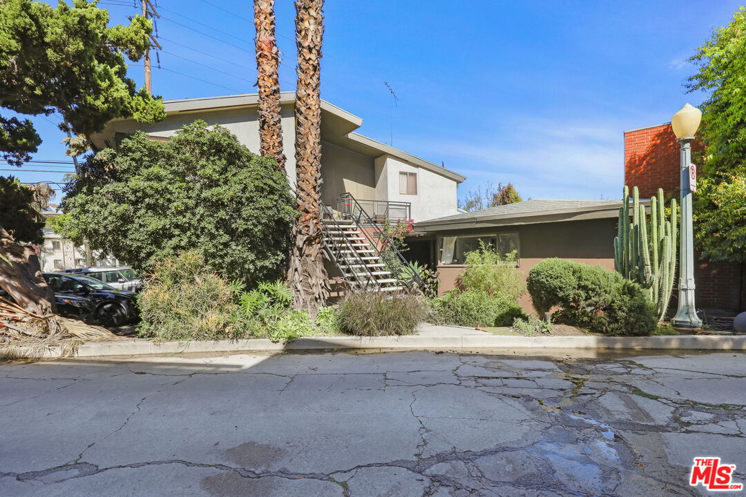3765 Arbolada Road Los Angeles, CA 90027 - Photo 28 of 34 a front view of a house with a yard and potted plants