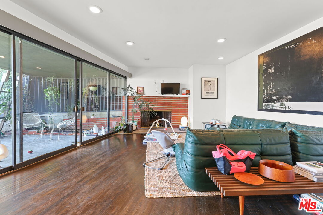 3765 Arbolada Road Los Angeles, CA 90027 - Photo 3 of 34 a living room with furniture and a floor to ceiling window