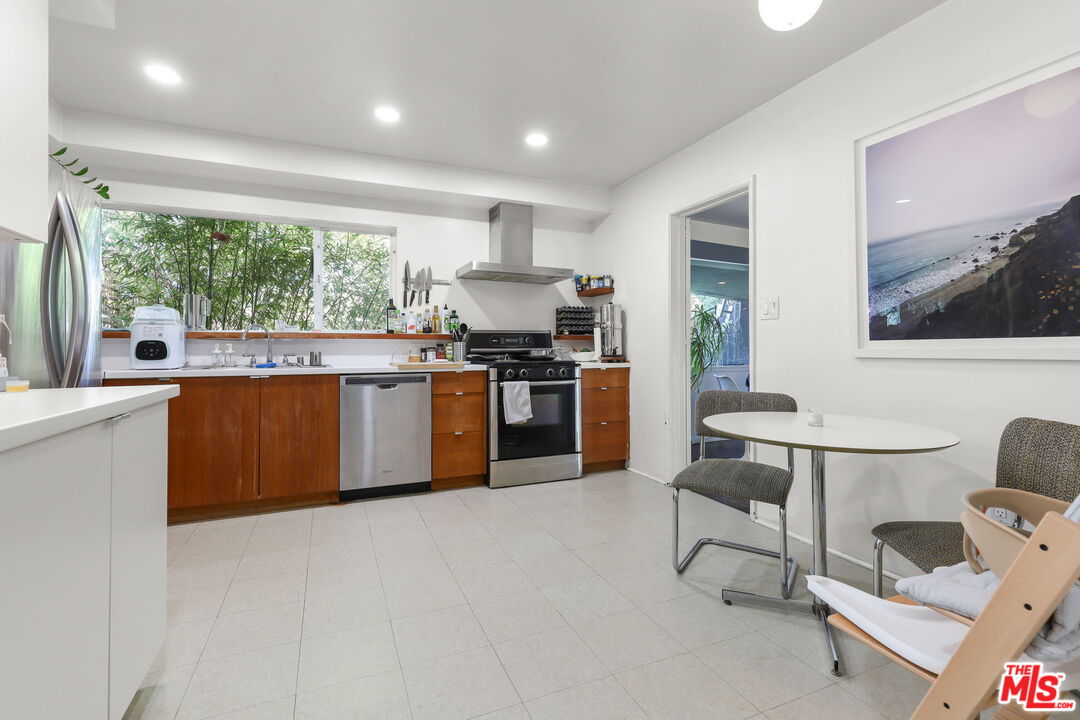 3765 Arbolada Road Los Angeles, CA 90027 - Photo 6 of 34 a kitchen with stainless steel appliances granite countertop a stove top oven a sink and a refrigerator